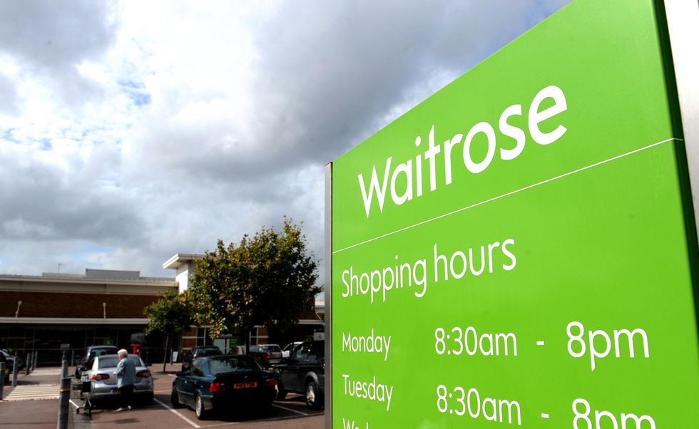 Waitrose supermarket car park and shopping hours sign