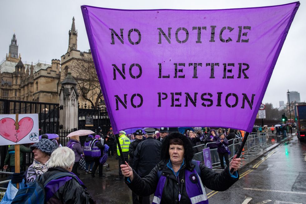 WASPI campaigner holds state pension banner