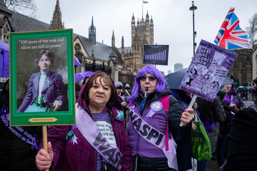 Waspi campaigners holding signs at protest