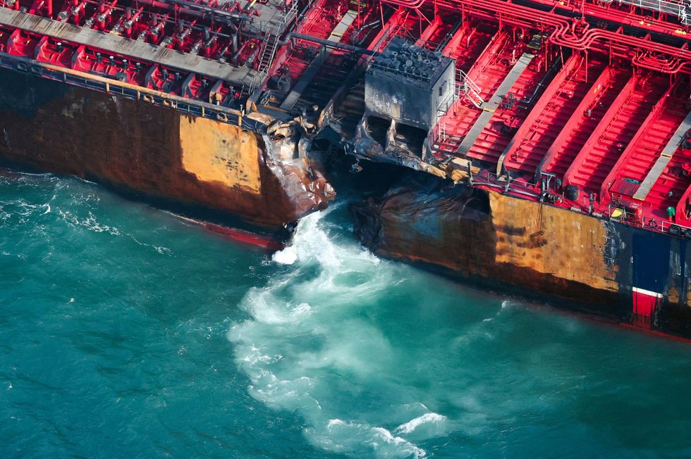 Water flows through a damaged hull of Stena Immaculate oil tanker ship