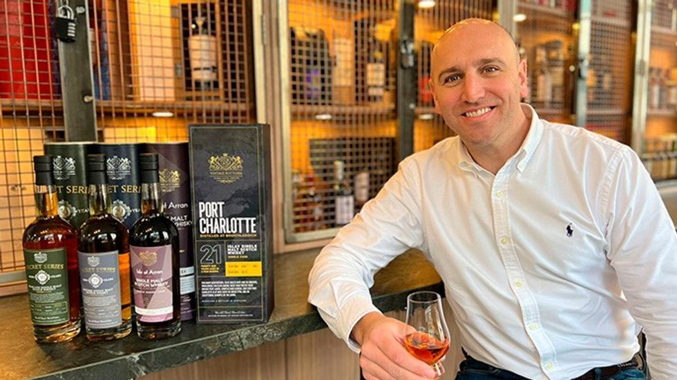 Whisky expert and Vintage Acquisitions\u2019 founding director Sam Brooks holds glass of whisky