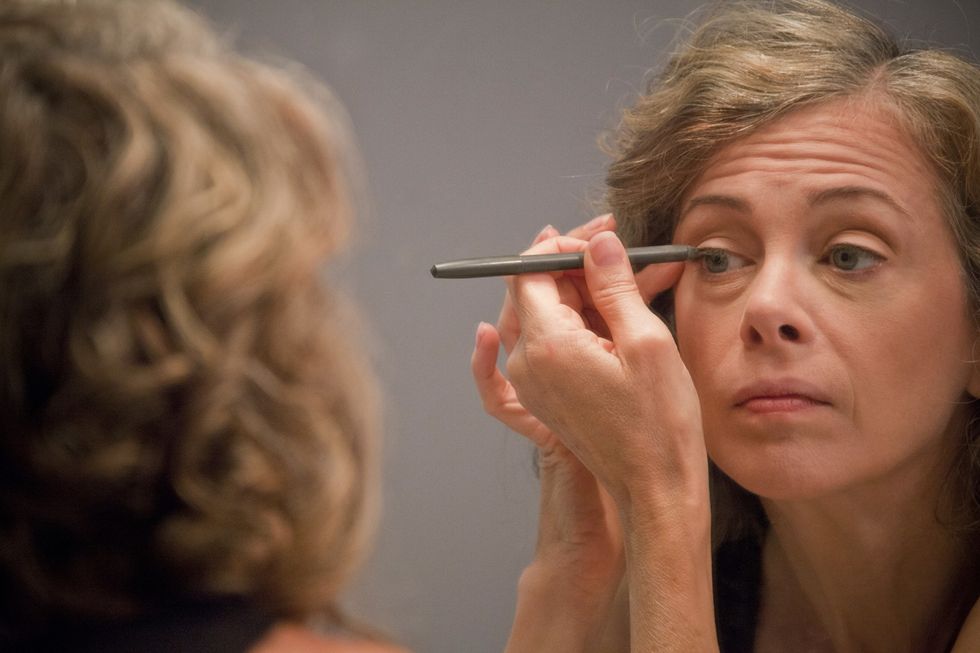 Woman applying eyeliner