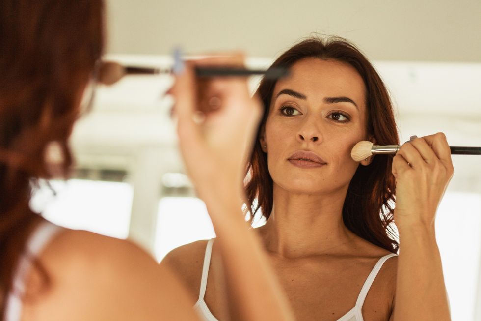 Woman applying makeup