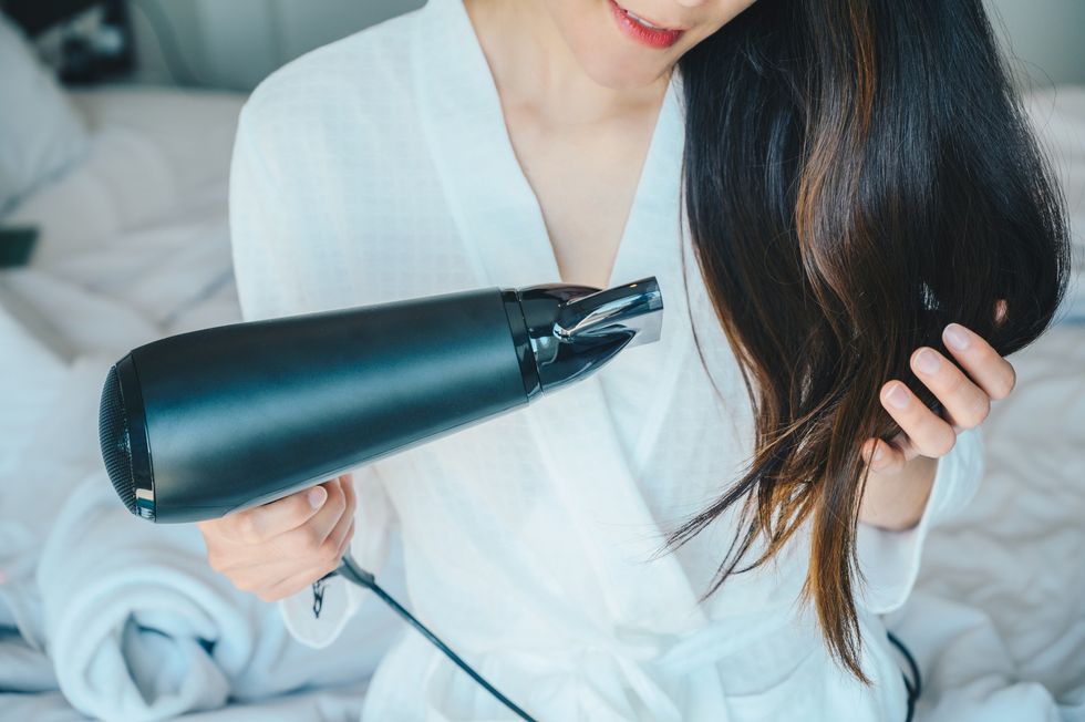 Woman blow-drying hair