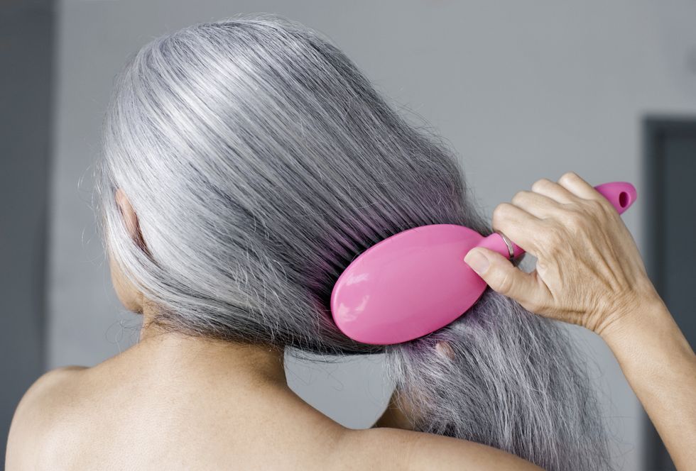 Woman brushing hair 