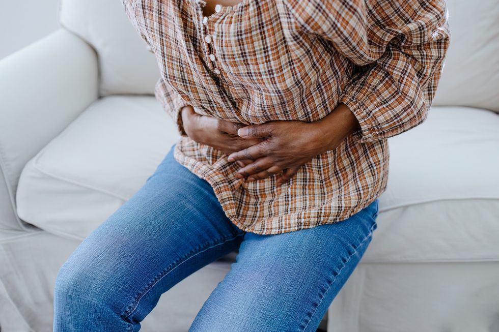 WOMAN CLUTCHING STOMACH