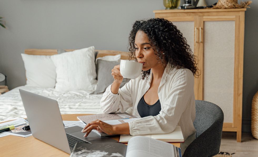 Woman drinking coffee at desk