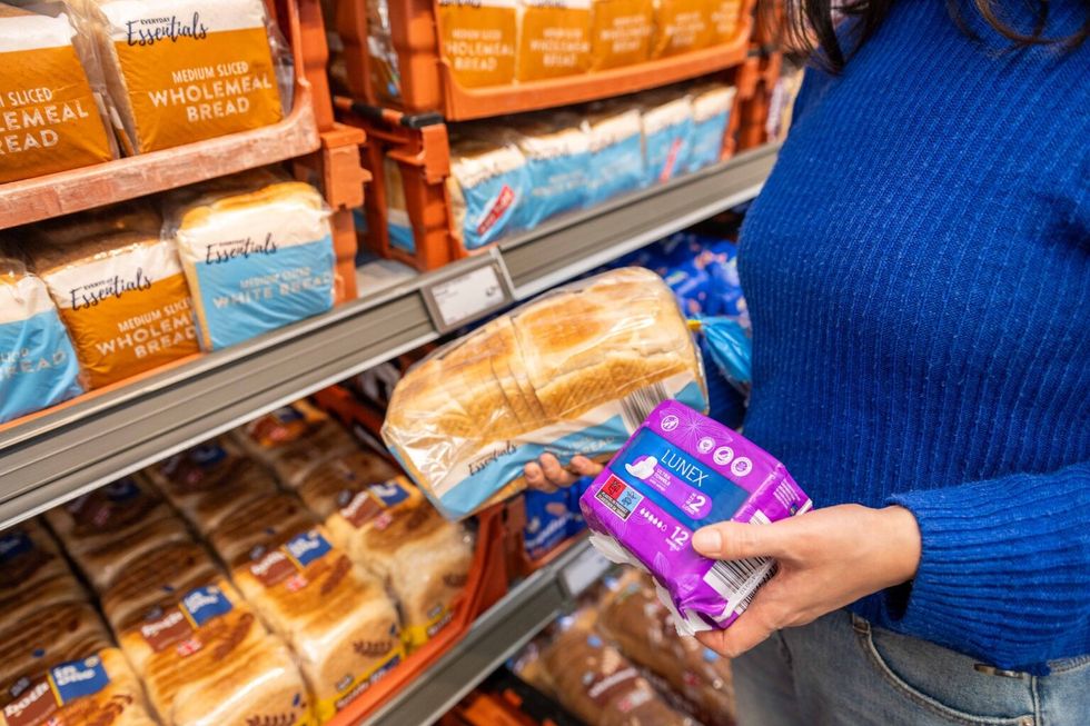 Woman holding bread and sanitary towels