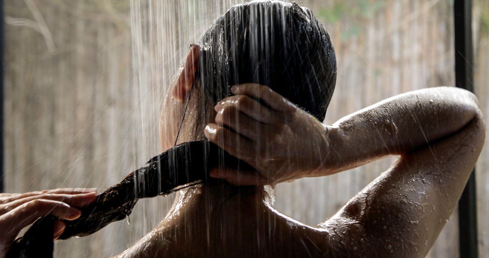 Woman in shower washing her hair