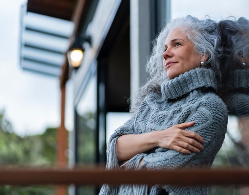 woman leaning against window