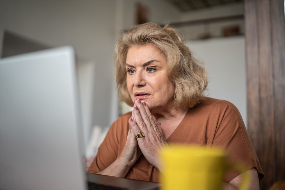 Woman shocked at laptop