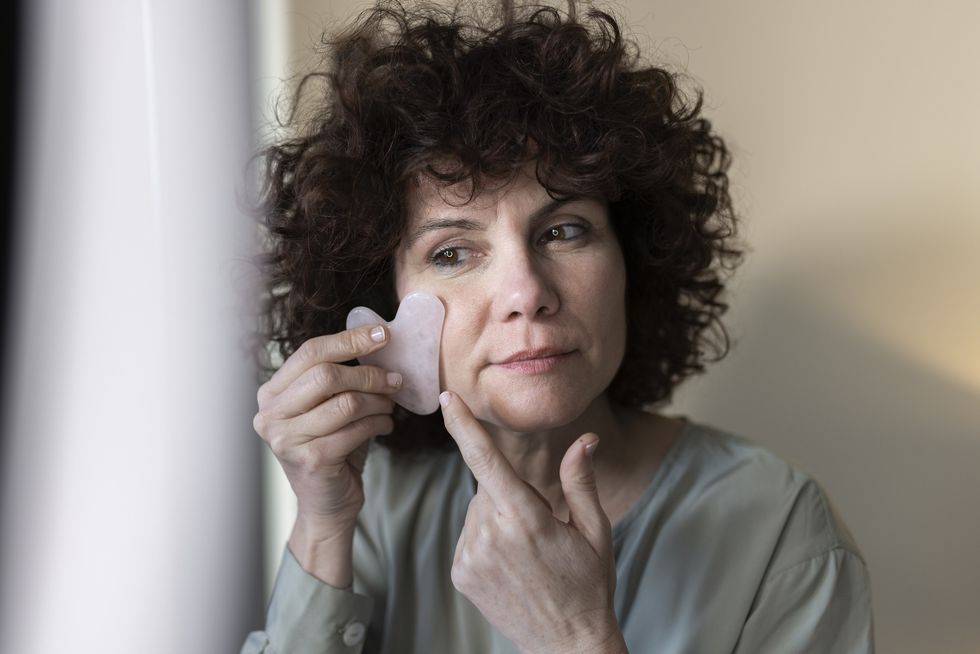 Woman using gua sha