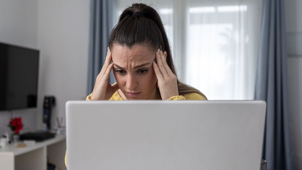 Woman worried at laptop