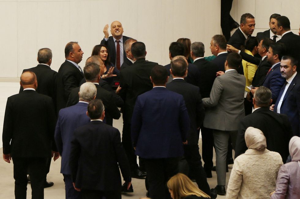 Workers' Party of Turkey (TIP) lawmaker Ahmet Sik argues with the ruling AK Party (AKP) lawmakers during an extraordinary meeting of the Turkish parliament